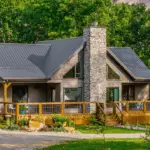 PHOTO OF farmhouse with wrap around porch, custom fireplace and completely custom build in tennessee
