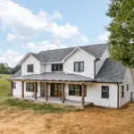 photo of a white farmhouse two stories custom built residential home in tennessee