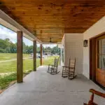 Front elevation with oversized porch posts and large covered porch in Monterey, Tennessee.