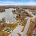 Aerial view of the bocce ball court site along a cove of the Fairfield Glade lake, with the surrounding community and roadway