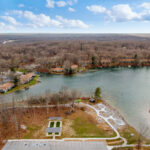Aerial view of the bocce ball court set back from the lake, with the surrounding Fairfield Glade community