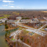 Aerial view of the bocce ball court site near the community entrance road and parking area in Fairfield Glade