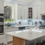 Detail of the herringbone tile backsplash accent above the range in the kitchen