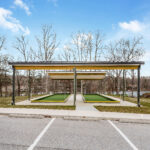 Head-on view of both bocce ball court shelters and all four turf lanes from the parking lot