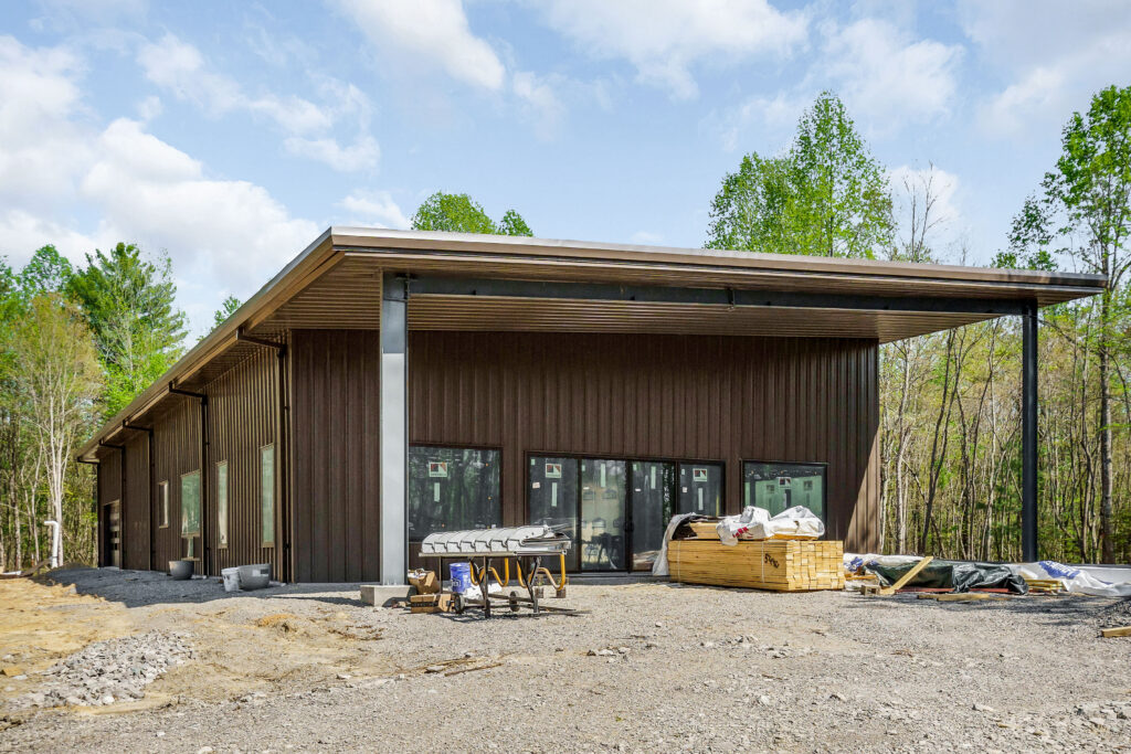 Ground level view of the covered porch corner on a single slope metal building home near Crossville, Tennessee